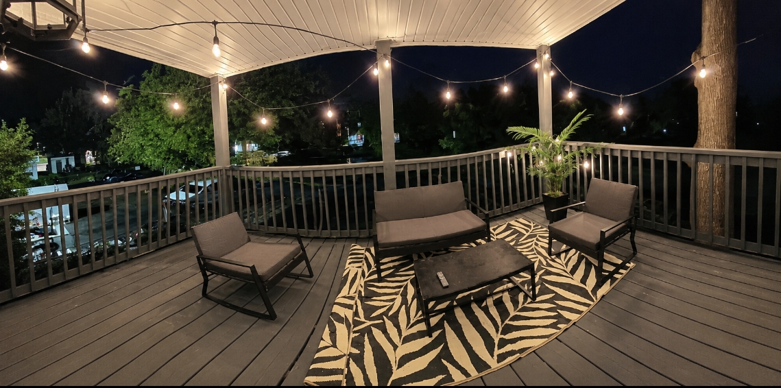 Covered deck at night with string lights