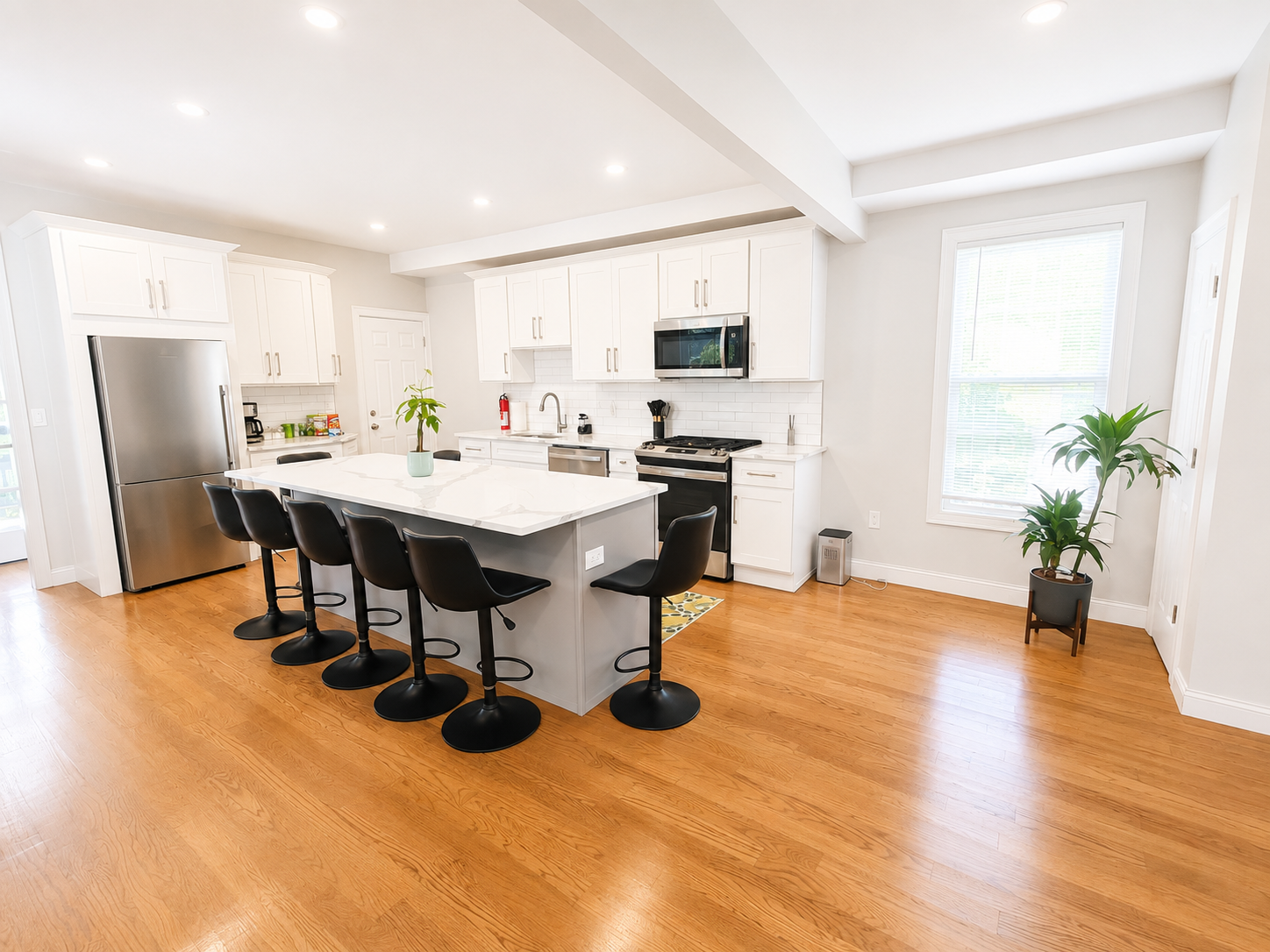 White kitchen with quartz island and bar stools